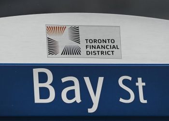 North American stock markets down in late-morning trading, loonie falls