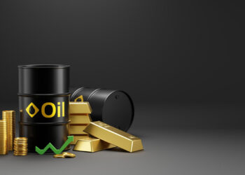 Two black oil barrels, gold bars, and stacked gold coins are arranged together on a dark background. A green upward arrow is placed in front, symbolizing rising commodity values. | ZIIMP
