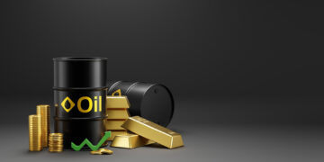 Two black oil barrels, gold bars, and stacked gold coins are arranged together on a dark background. A green upward arrow is placed in front, symbolizing rising commodity values. | ZIIMP