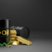 Two black oil barrels, gold bars, and stacked gold coins are arranged together on a dark background. A green upward arrow is placed in front, symbolizing rising commodity values. | ZIIMP